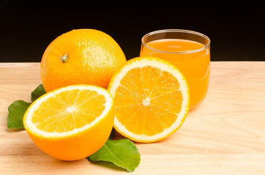 Navel orange fruit and juice on wooden background