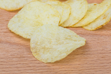 Potato chips on wood board