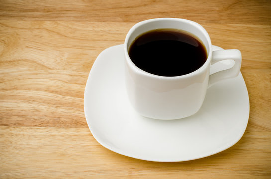 Hot coffee (black coffee) on wooden background