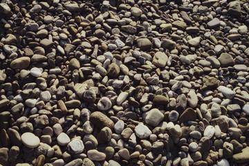 Surface covered with gray stones rounded pebbles