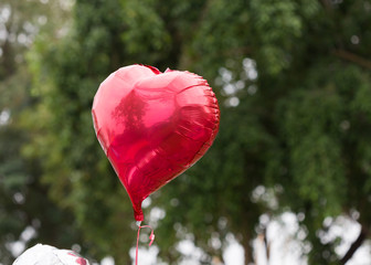 red balloon heart decorated in the outdoor party