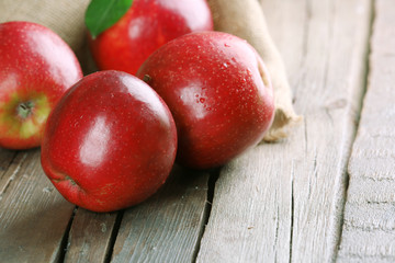 Ripe red apples on table close up