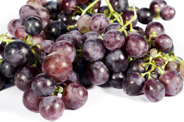 Bunch of red table grapes on white