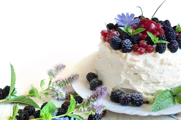 Handmade cake with sweet cream blackberries and red currants and