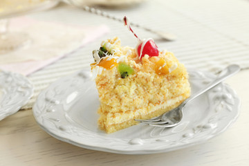 Peace of tasty Butter cake on plate, on color wooden background