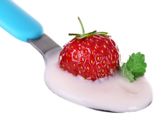 Delicious yogurt in spoon with strawberry and mint isolated on white