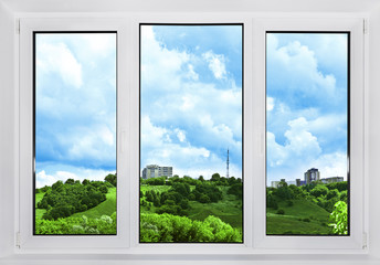 Modern plastic window with a view of the sky, nature and the city