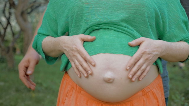 Parent's Hands on Belly with Unborn Child