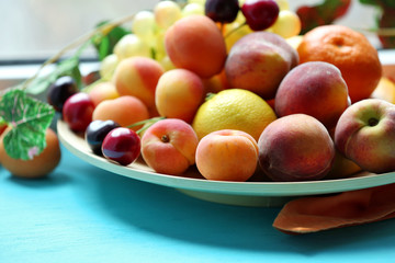 Fototapeta na wymiar Heap of fresh fruits on windowsill