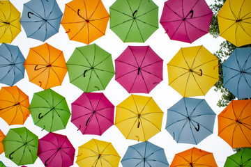 Fototapeta na wymiar different colored umbrellas hanging in the air