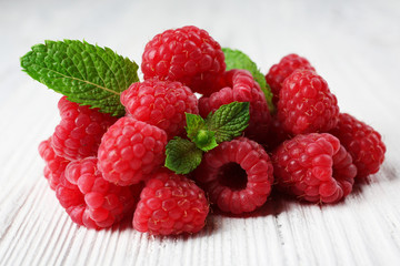 Fresh red raspberries on wooden table, closeup