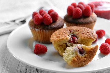 Delicious cupcakes with berries on plate close up
