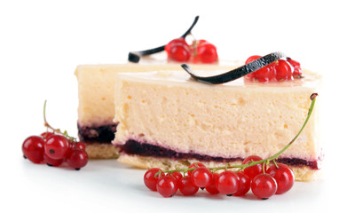Tasty pieces of cheesecake with berries isolated on white