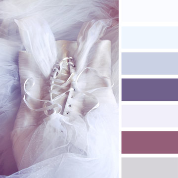 vintage cream girl's dress on wooden background with palette color swatches