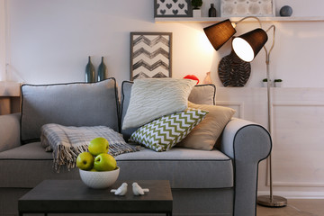Beautiful modern living room with grey sofa and floor lamp