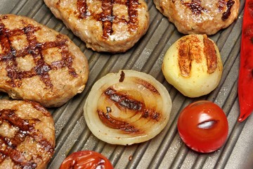 Close-up of homemade pan-fried burgers in grill-pan. Top View