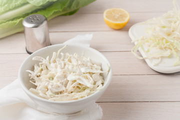 white cabbage cole slaw in white bowl