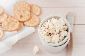 chunks of cheese with sundried tomatoes, herbs and spices