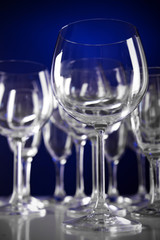 Empty wine glasses on blue background
