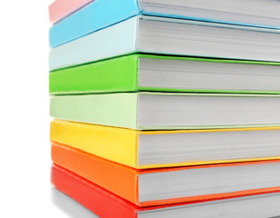 Colorful books close-up on white background