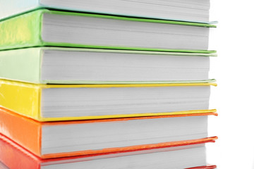 Colorful books close-up on white background