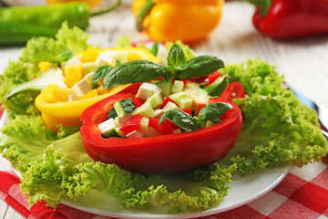 Fresh green salad in pepper on table close up