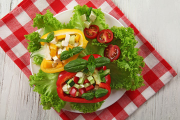 Fresh green salad in pepper on table close up