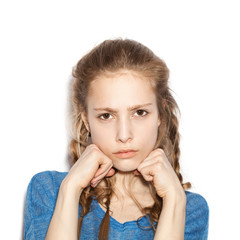 girl with two hands in fists, face contorted in anger