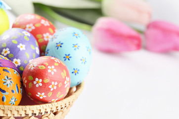Fototapeta na wymiar Easter eggs, basket, flowers
