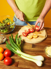 Middle-aged man cook fresh salad