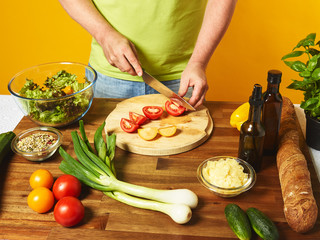 Middle-aged man cook fresh salad