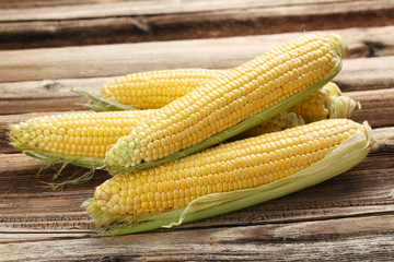 Corns on a brown wooden background