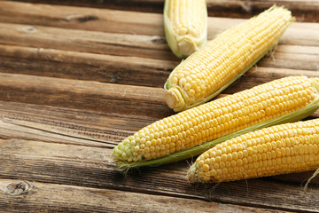 Corns on a brown wooden background