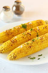 Fresh tasty grilled corn on white plate