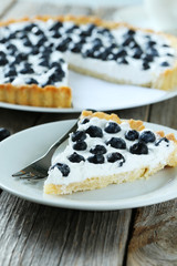 Sweet tart cake with blueberries on grey wooden background