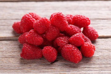 Red raspberries on grey wooden background