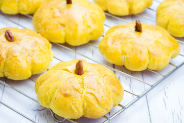 Fresh homemade pumpkin buns on a cooling rack