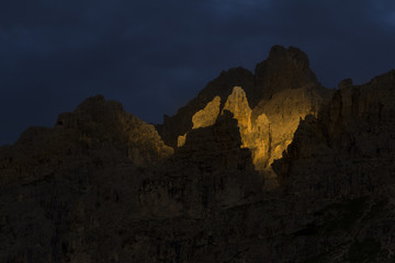 Dramatic light t sunset in Dolomites Mountains