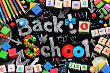 School supplies on black schoolboard background