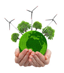 Green planet with trees and wind turbines in hands