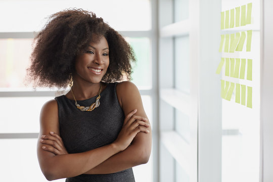 Portrait of a smiling business woman with an afro in bright