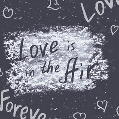 Hand drawn phrases. "Love is in the Air". Chalk on the blackboar