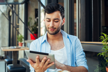 Young man holding digital tablet