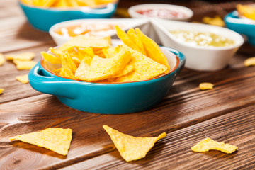 Plate of nachos with different dips