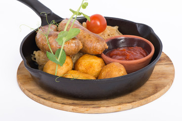 grilled sausages with potato in pan