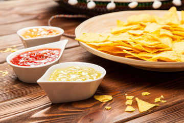 Plate of nachos with different dips
