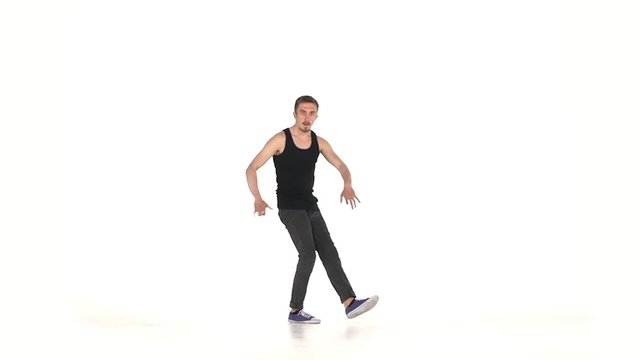 Young b-boy man doing brake dancing movements, on white, slow