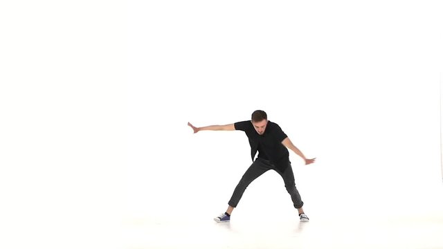 Modern dancer dancing brake-dance on hands, white, slow motion