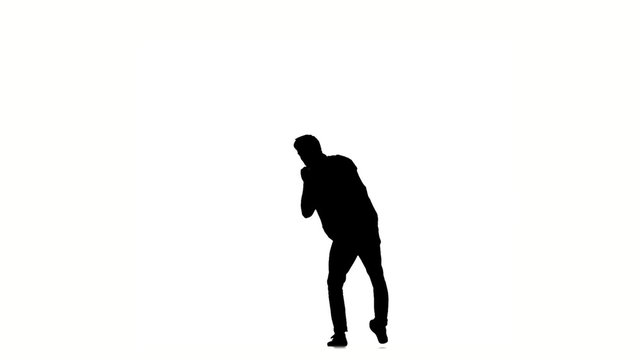Young hip-hop man doing brake dancing movements, on white, slow