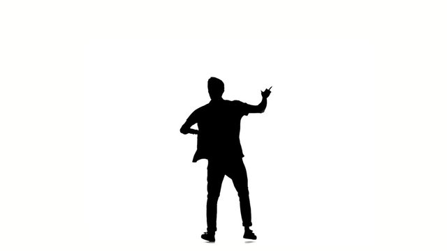 Young hip-hop man in shirt doing brake dancing movements, on